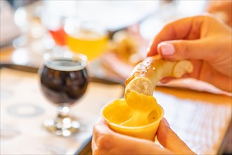 Woman enjoys warm pretzels and micro brew beer