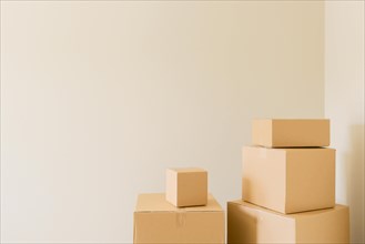 Variety of packed moving boxes in empty room with room for text