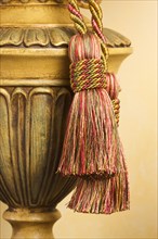 Lamp on table with ornate hanging tassel