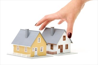 Female hand reaching for house isolated on a white background