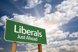 Liberals green road sign with dramatic clouds