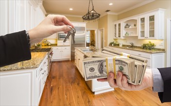Handing over keys for cash in beautiful custom kitchen interior