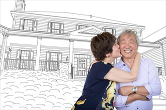 Chinese senior adult couple kissing in front of custom house drawing plans