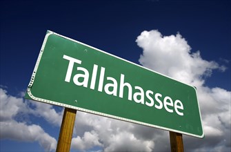Tallahassee road sign with dramatic blue sky and clouds