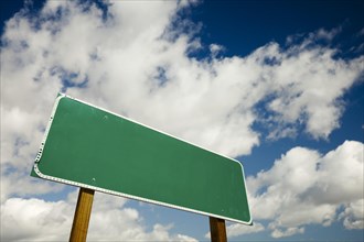 Blank road sign with dramatic clouds and sky ready for your own copy