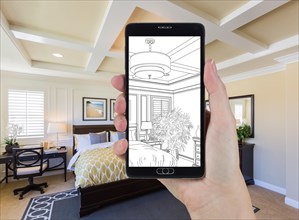 Hand holding smart phone displaying drawing of custom bedroom photo behind