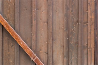 Wooden wall with rusty metal beam background