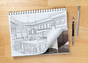 Sketch pad on desk with drawing of custom kitchen and page corner turning to show finished construction next to engineering pencil and ruler scale