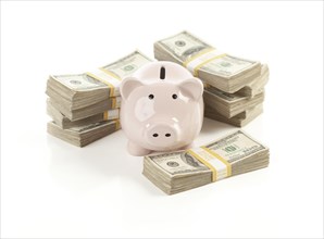 Pink piggy bank with stacks of hundreds of dollars isolated on a white background