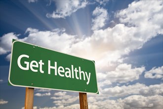 Get healthy green road sign with dramatic clouds