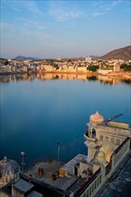 View of famous indian hinduism pilgrimage town sacred holy hindu religious city Pushkar amongst hills with Brahma mandir temple