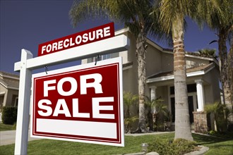 Foreclosure for sale real estate sign in front of house