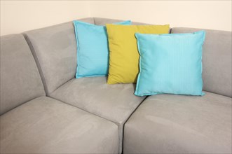 Abstract of grey suede couch & pillows