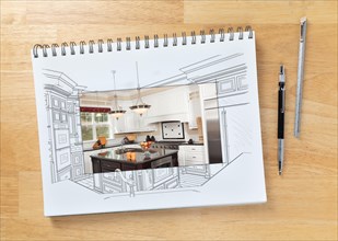 Sketch pad on desk with drawing of custom kitchen and square section showing finished construction next to engineering pencil and ruler scale