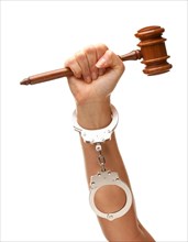 Handcuffed woman holding wooden gavel in her fist isolated on a white background