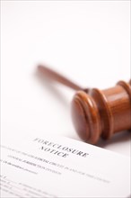 Foreclosure notice and gavel on gradated background with selective focus