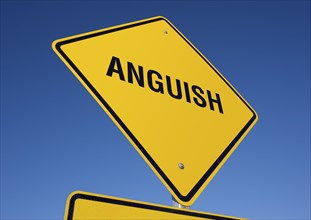Anguish yellow road sign against a deep blue sky with clipping path