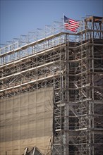 Majestic american flag flying on top of new building construction