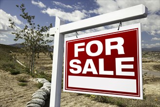 For sale real estate sign and emtpy construction lots