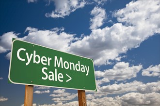 Cyber monday sale green road sign with dramatic clouds and sky