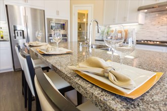 Abstract of beautiful kitchen granite counter place settings and chairs