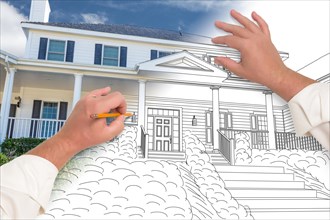 Male hands sketching with pencil the outline of a house with photo showing through