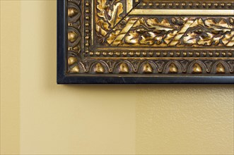 Ornate picture frame abstract on light yellow wall