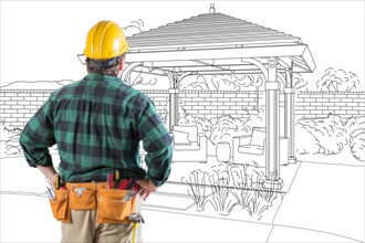 Contractor standing looking at patio pergola design drawing