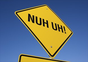 Nuh uh! yellow road sign against a deep blue sky with clipping path