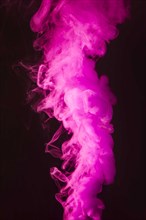 Abstract dense fluffy puffs of pink smoke on black background