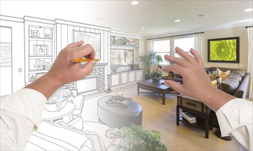 Male hands drawing custom living room design gradating into photograph