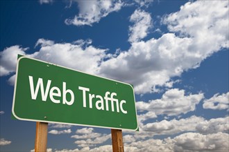 Web traffic green road sign with dramatic sky and clouds