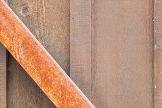 Wooden wall with rusty metal beam background