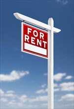 Left facing for rent real estate sign on a blue sky with clouds