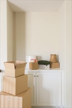 Variety of packed moving boxes and materials in empty room