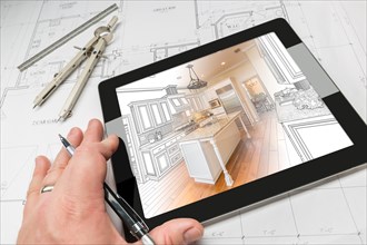 Hand of architect on computer tablet showing custom kitchen illustration photo combination over house plans