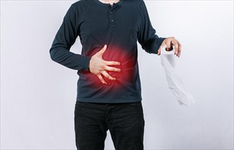 Man with stomach problems holding toilet paper