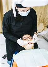 Dentist examining mouth to patient