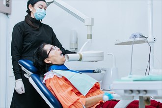 A female dentist performing dental x-rays