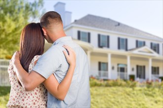 Affectionate military couple looking at nice new house