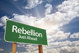 Rebellion green road sign with dramatic clouds