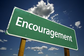 Encouragement road sign with dramatic clouds and sky