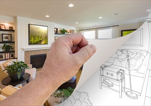 Male hand turning page of custom living room photograph to drawing underneath