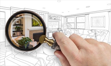 Hand holding magnifying glass revealing custom living room design drawing and photo combination