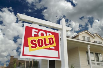 Sold home for sale sign in front of new house