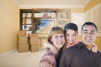 Happy young mixed-race family in room with moving boxes and drawing of entertainment unit on wall