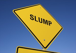 Slump yellow road sign against a deep blue sky with clipping path