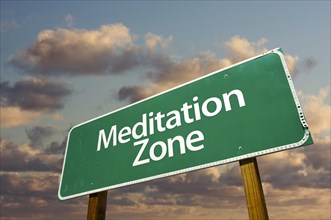 Meditation zone green road sign in front of dramatic clouds and sky