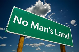 No man's land green road sign on dramatic clouds and blue sky
