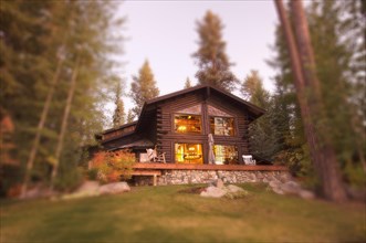 Beautiful log cabin exterior among pine trees